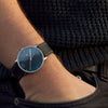 Vanacci carbon leather Watch worn by a man with a blue jumper 