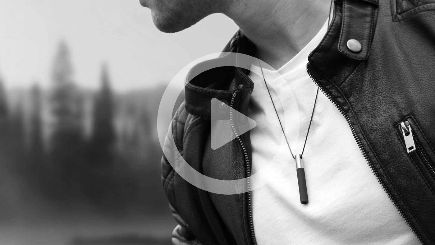 Man wearing Lockstone pendant on lakeside