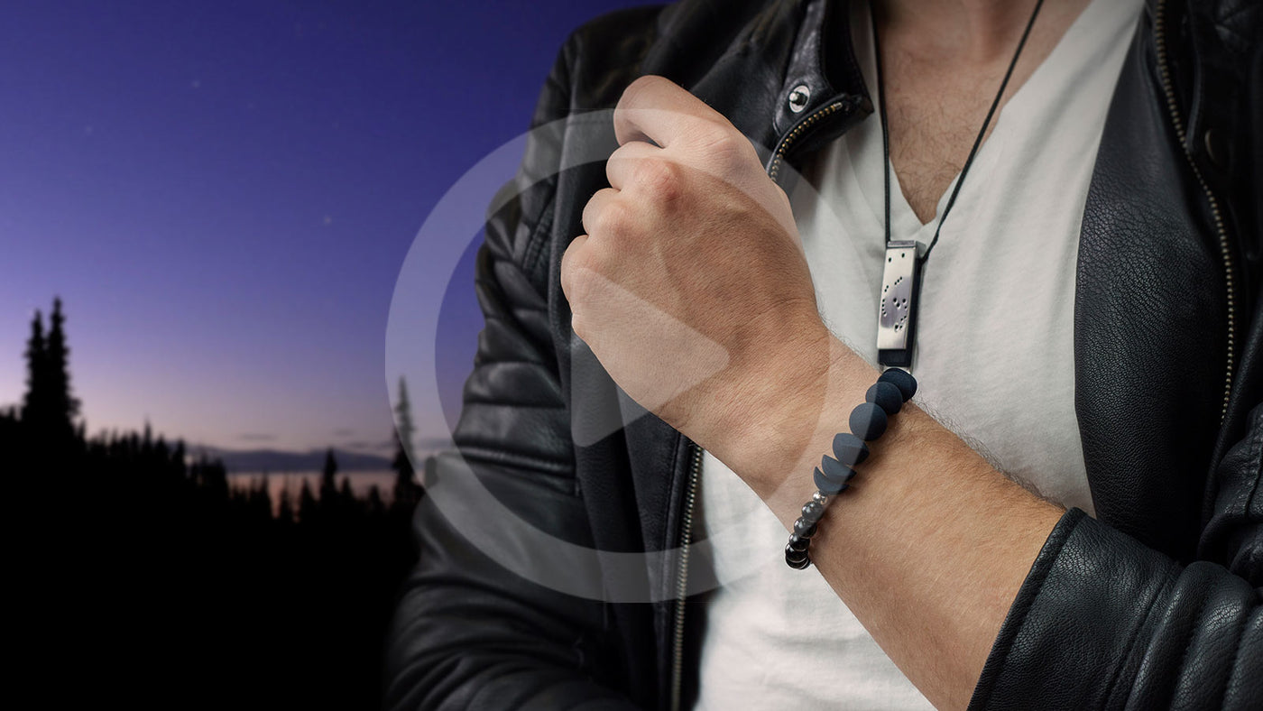 Nightfall pendant worn on a man with a bracelet on a starfield