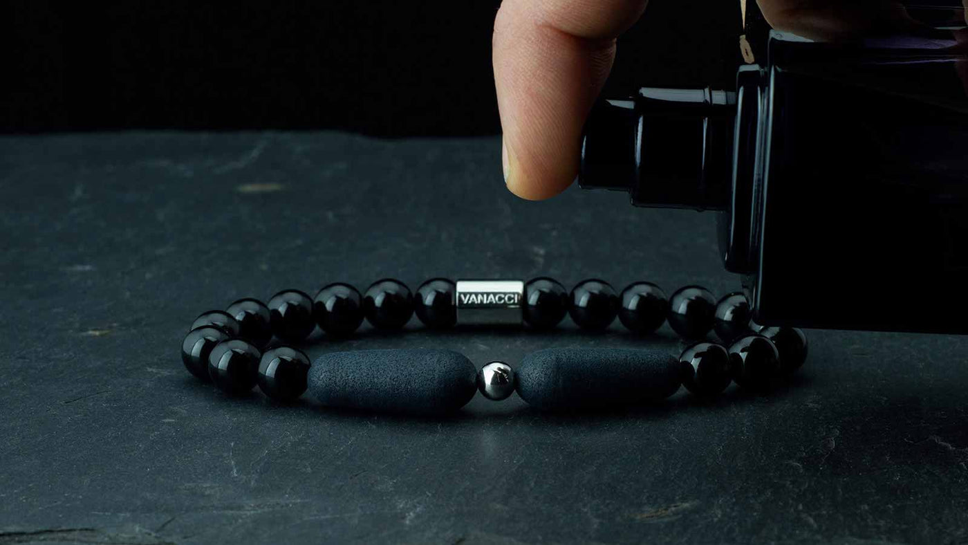 Black Lockstone bracelet being sprayed with perfume