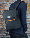 Vanacci canvas laptop backpack in black and orange on a man