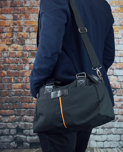 Vanacci canvas messenger bag in black worn by a man