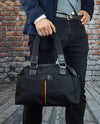 Vanacci canvas messenger bag in black held by a man