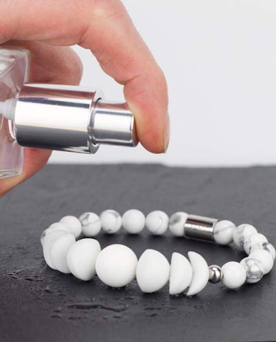 Vanacci Lockstone All White Perfume Bracelet being sprayed with fragrence